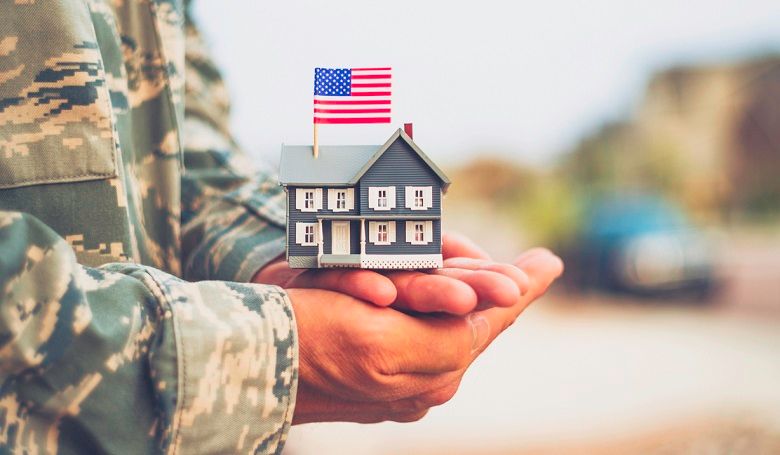 Veteran Holding Model House with American Flag